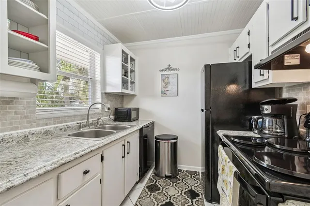 a kitchen with a sink stove and cabinets