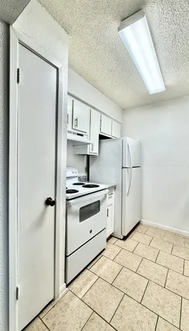 a kitchen with stainless steel appliances a refrigerator sink and cabinets