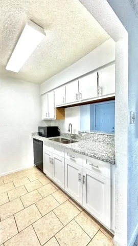 a kitchen with stainless steel appliances granite countertop a sink and cabinets