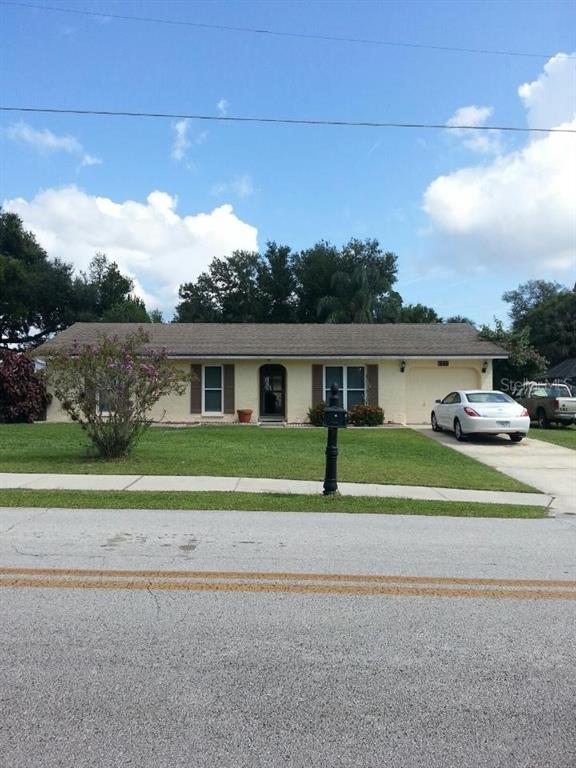 10 Valencia Road DeBary, FL 32713 - Photo 1 of 1 a front view of a house with a yard and potted plants