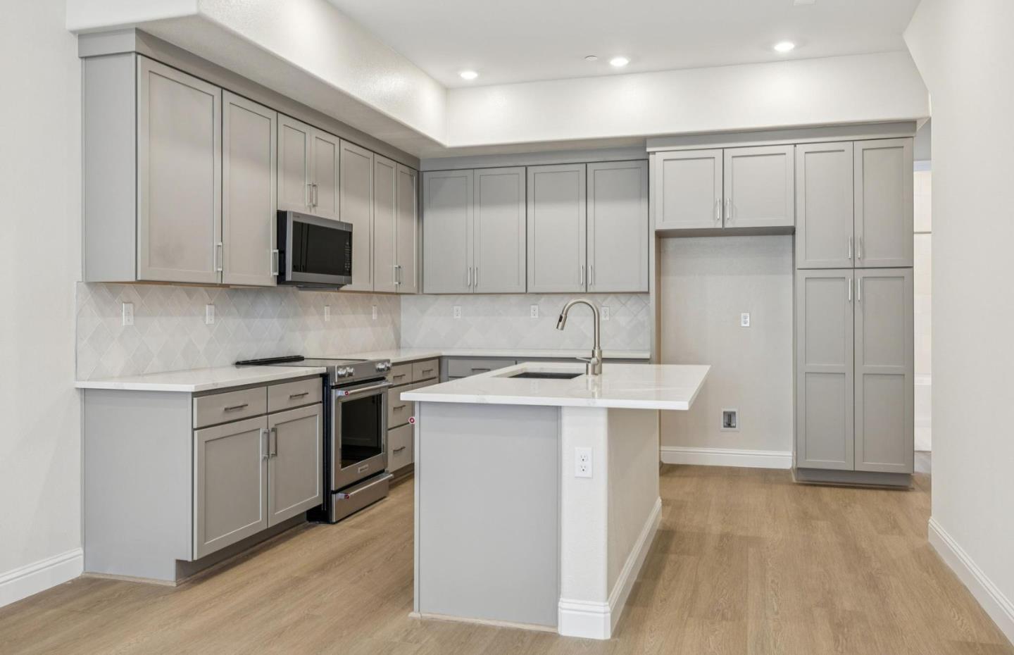 2417 Willow Way San Mateo, CA 94403 - Photo 10 of 34 a kitchen with stainless steel appliances a stove sink and microwave