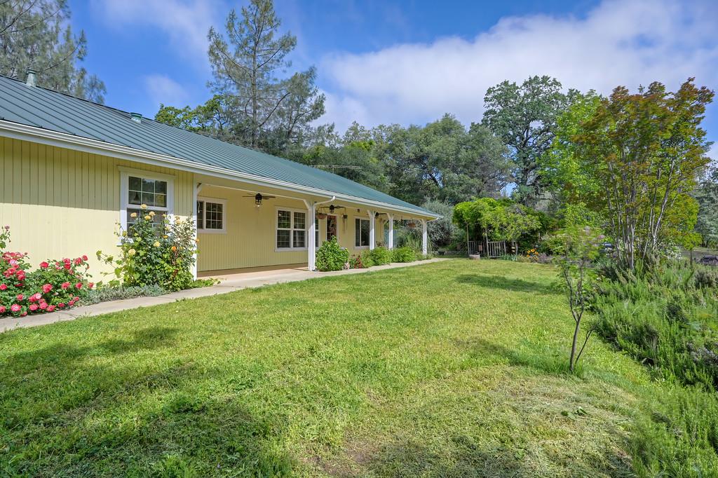 6181 Lambert Lane El Dorado, CA 95623 - Photo 2 of 68 view of grassy yard with ceiling fan and covered porch
