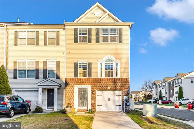 a front view of a residential apartment building with a yard
