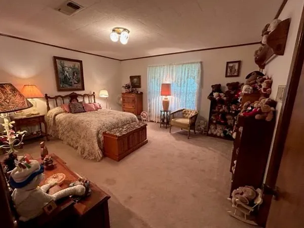 a bedroom with bed and a large mirror
