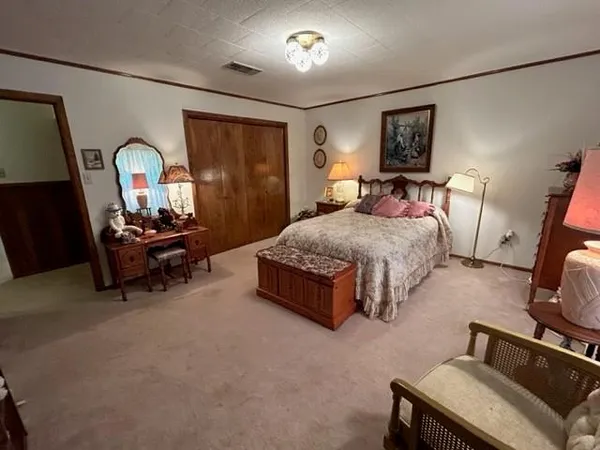 a living room with a bed furniture and a window