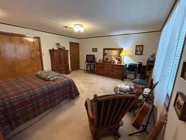 a bedroom with furniture and a flat screen tv