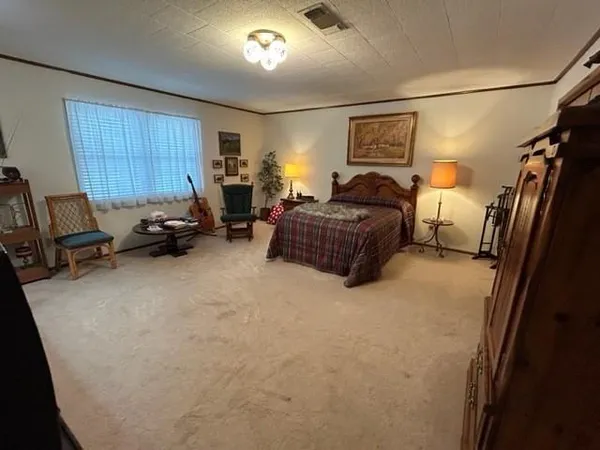 a bedroom with furniture and a window