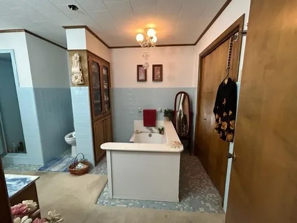 a bathroom with a sink a toilet and mirror