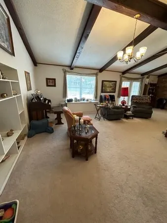a living room with furniture and a chandelier