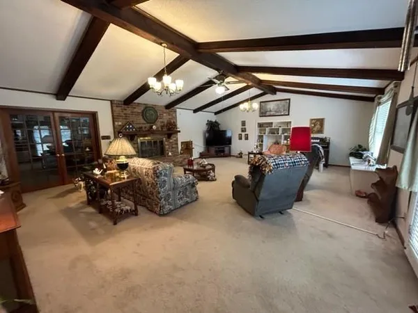 a living room with furniture and a gym cycle
