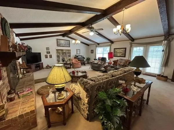 a living room with lots of furniture and a chandelier