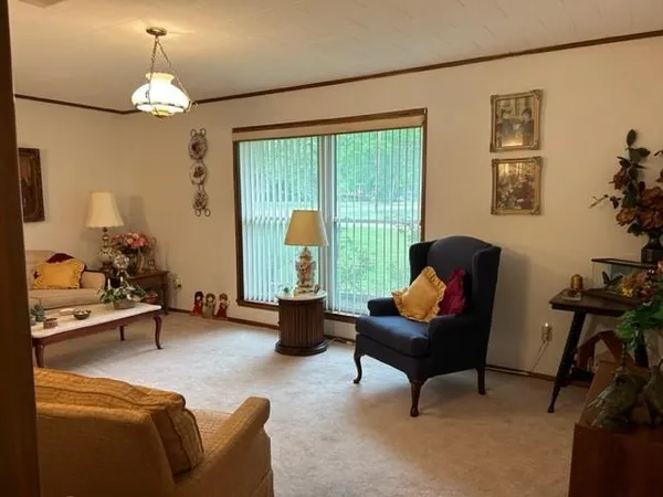 a living room with furniture and a chandelier