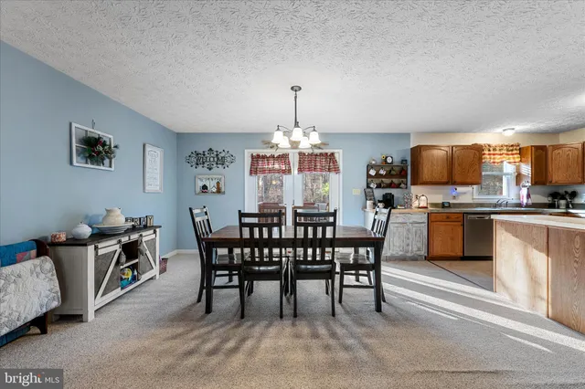a dining room with furniture and a chandelier