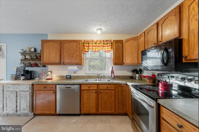 a living room with furniture a dining table and a fireplace