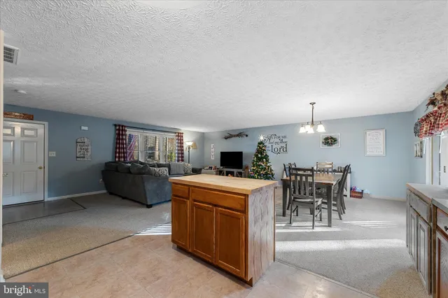 a spacious bedroom with a bed and a chandelier