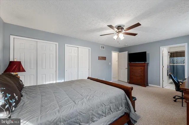 a living room with a baby crib furniture and a window