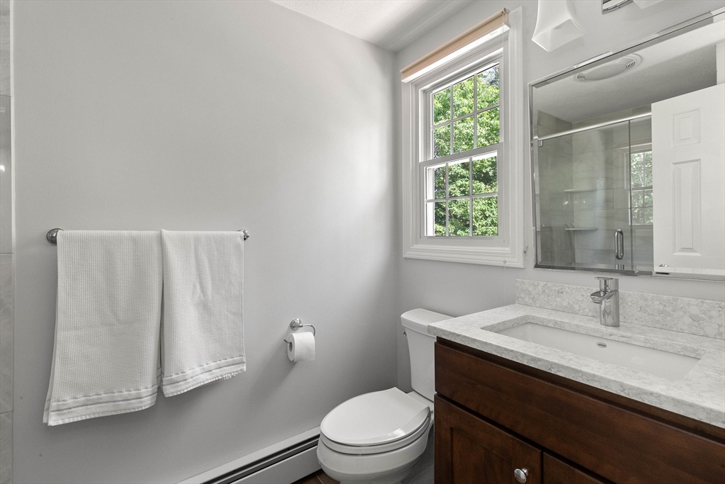 6 Arrowhead Farm Road Boxford, MA 01921 - Photo 29 of 42 a bathroom with a sink a toilet and a window