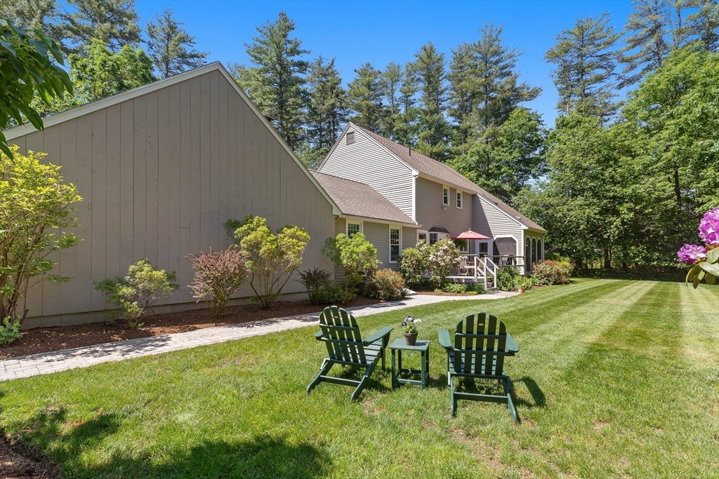 6 Arrowhead Farm Road Boxford, MA 01921 - Photo 3 of 42 a view of a chair and table in backyard of the house