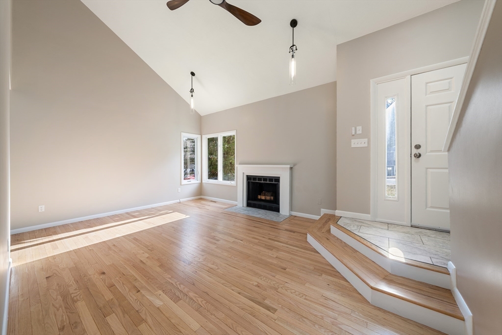 5 Lanes End Natick, MA 01760 - Photo 7 of 27 a view of a livingroom with wooden floor and a fireplace