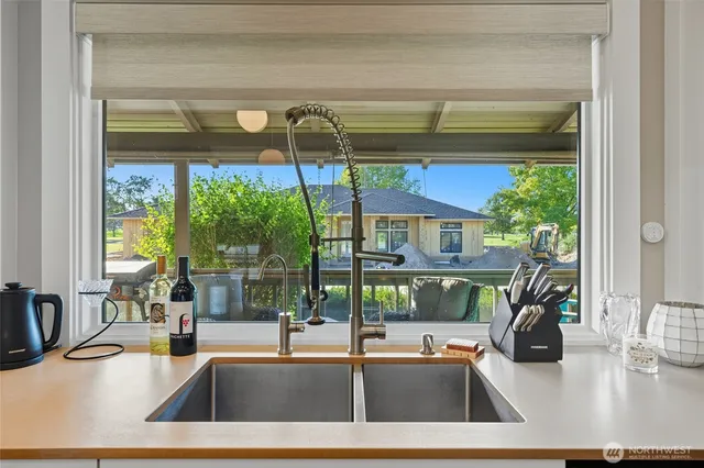 a kitchen with a sink and a large window