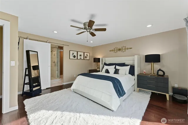 a bedroom with a large bed and a chandelier