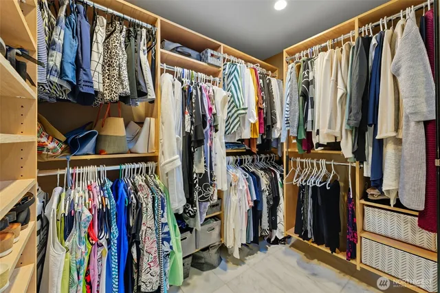 a view of walk in closet with clothes