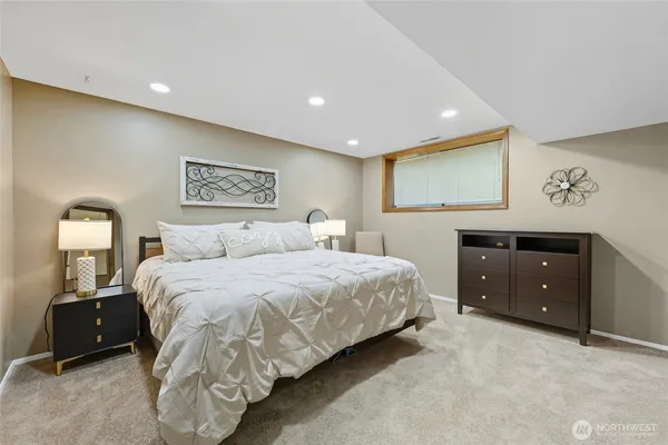 a bedroom with a bed and a night stand