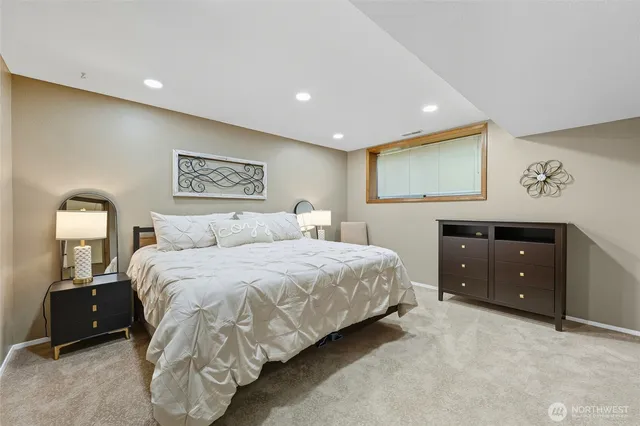 a bedroom with a bed and a night stand