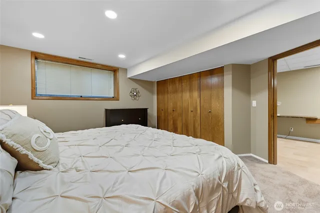 a bedroom with a bed and painting on the wall