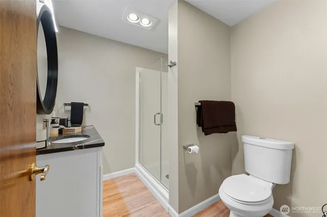 a bathroom with a toilet a sink and a mirror