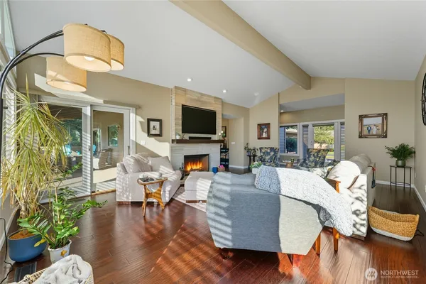a living room with fireplace furniture and a wooden floor