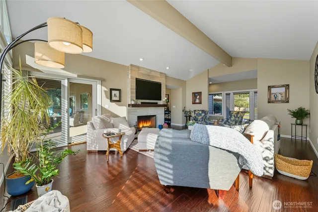 a living room with fireplace furniture and a wooden floor