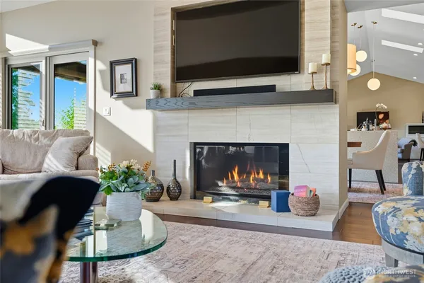 a living room with furniture a flat screen tv and a fireplace