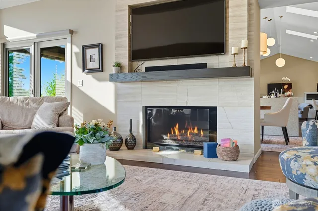 a living room with furniture a flat screen tv and a fireplace