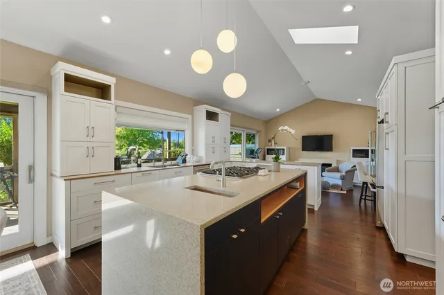 a kitchen with lots of counter top space and living room view