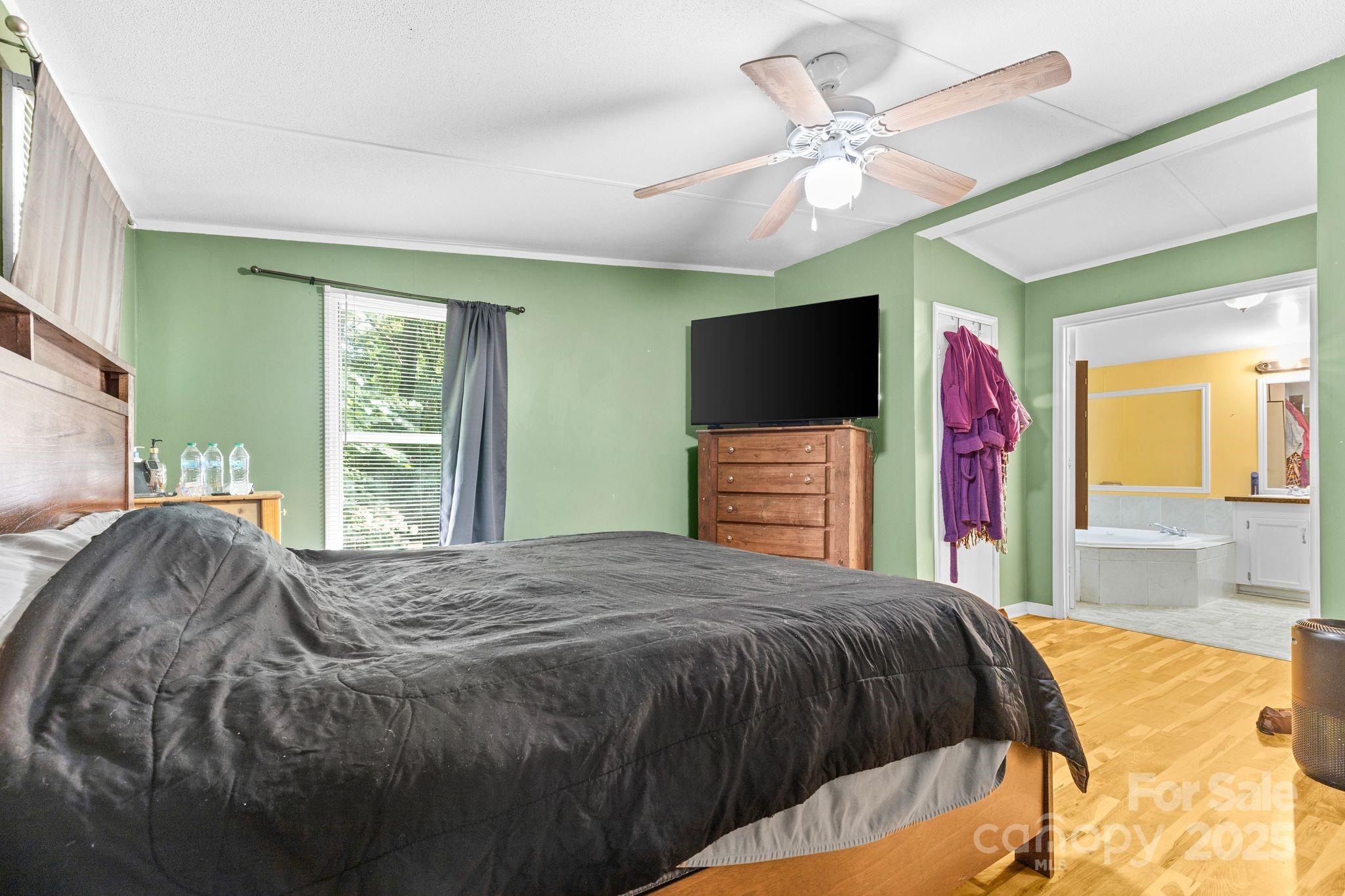 1902 Rock Hollar Road Stanley, NC 28164 - Photo 11 of 27 a bedroom with a bed and a flat screen tv
