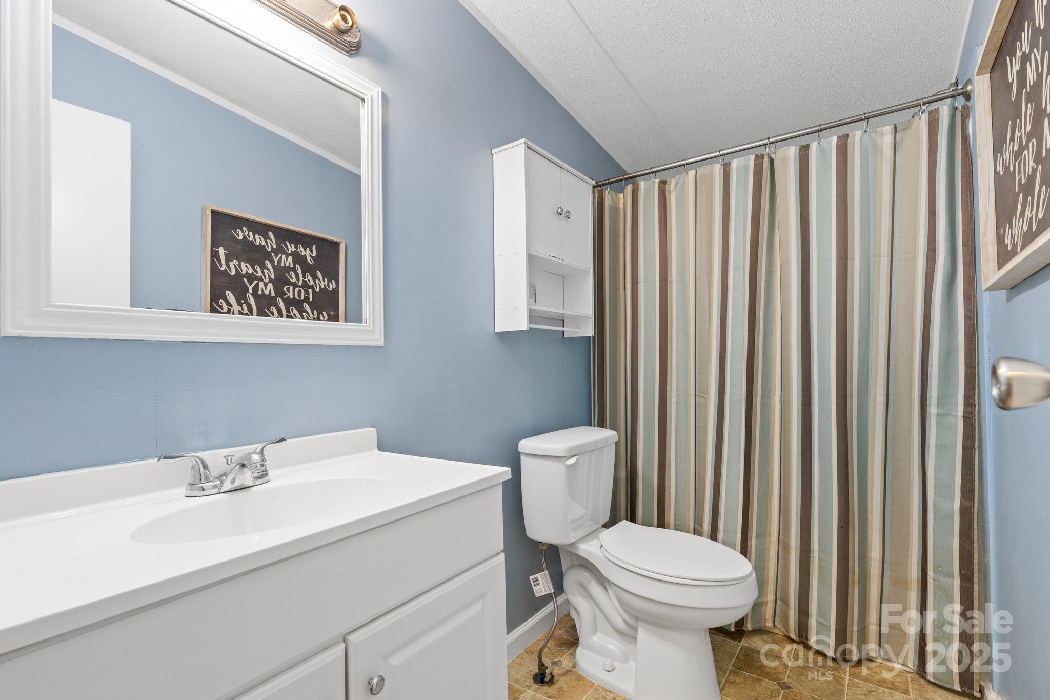 1902 Rock Hollar Road Stanley, NC 28164 - Photo 14 of 27 a white toilet sitting next to a bathroom sink