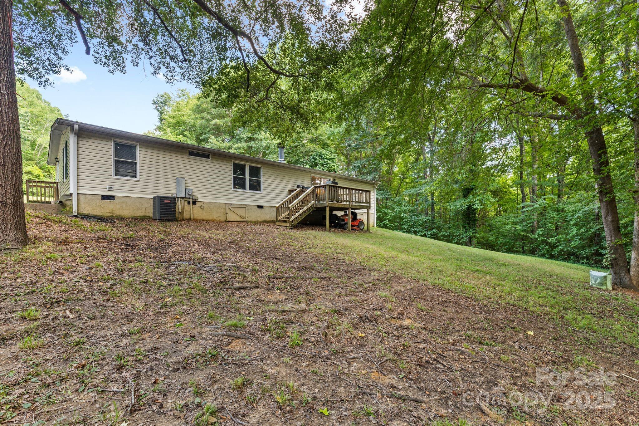 1902 Rock Hollar Road Stanley, NC 28164 - Photo 16 of 27 a house with trees in the background