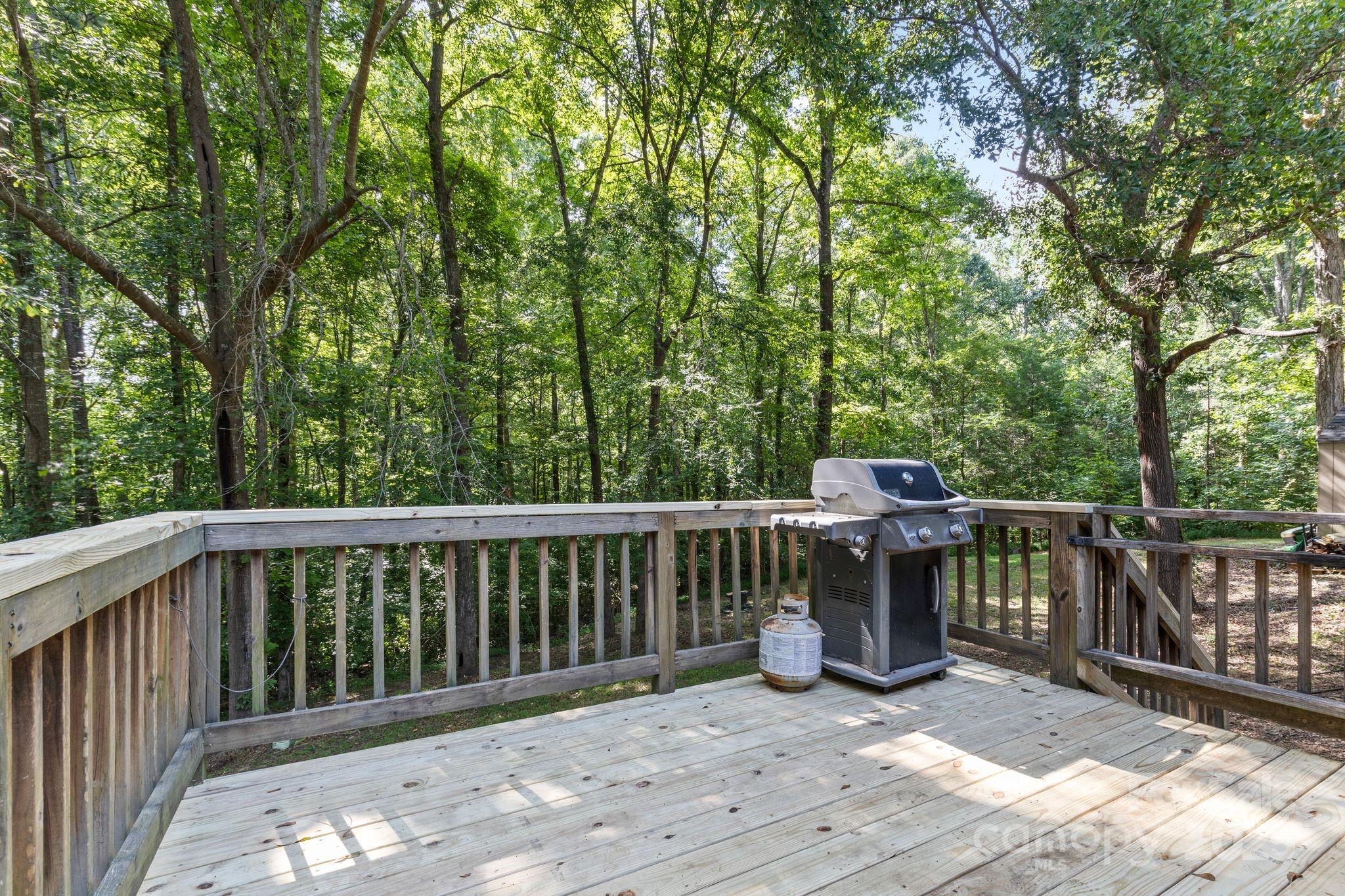1902 Rock Hollar Road Stanley, NC 28164 - Photo 18 of 27 a view of a deck with two chairs and wooden fence