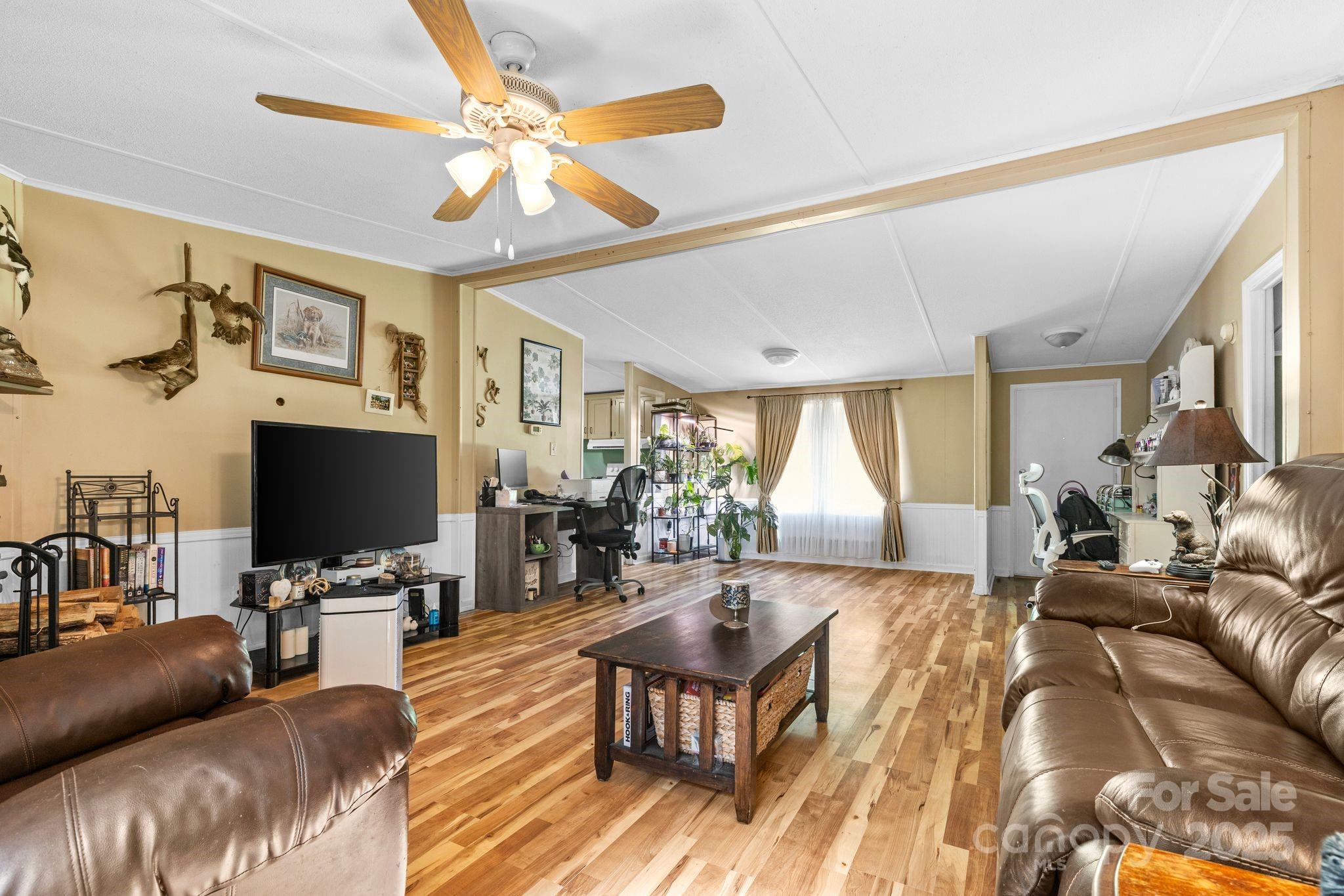 1902 Rock Hollar Road Stanley, NC 28164 - Photo 6 of 27 a living room with furniture and a flat screen tv