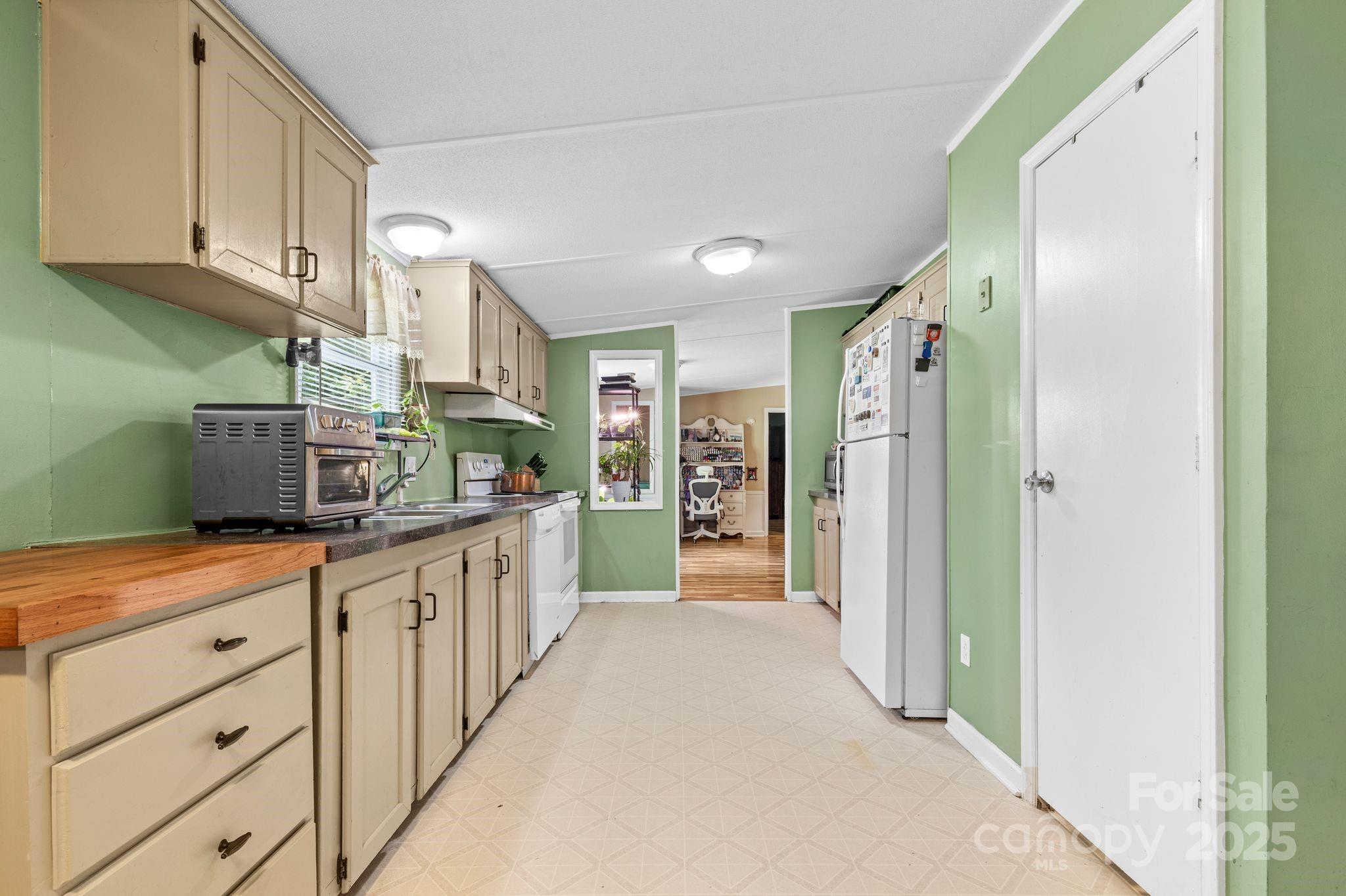 1902 Rock Hollar Road Stanley, NC 28164 - Photo 8 of 27 a kitchen with stainless steel appliances kitchen island granite countertop a refrigerator and a sink
