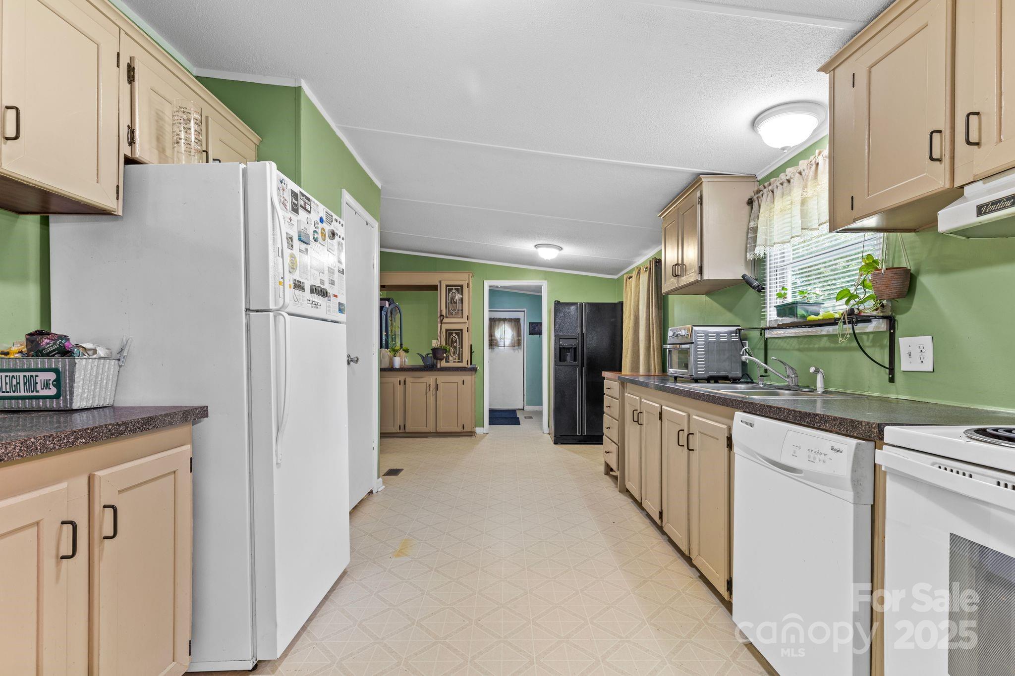 1902 Rock Hollar Road Stanley, NC 28164 - Photo 9 of 27 a kitchen with stainless steel appliances granite countertop a refrigerator and a sink