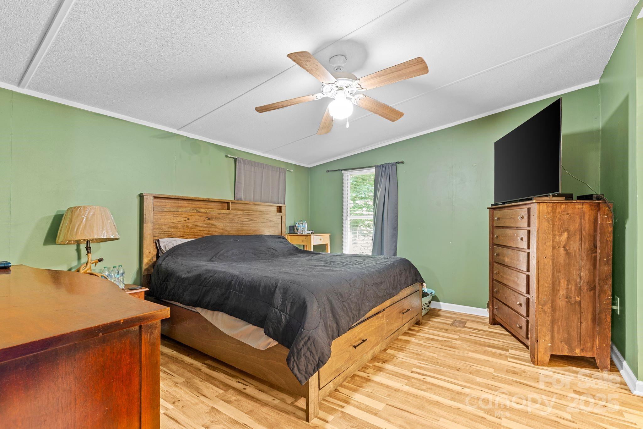 1902 Rock Hollar Road Stanley, NC 28164 - Photo 10 of 27 a bedroom with a bed and wooden floor