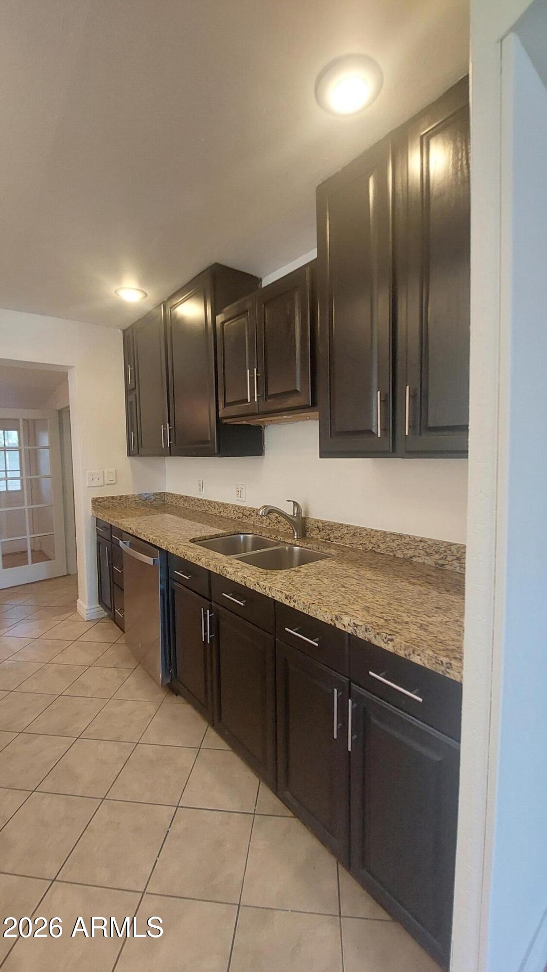 2448 West Freeway Lane Phoenix, AZ 85021 - Photo 8 of 27 a large kitchen with granite countertop a sink and cabinets