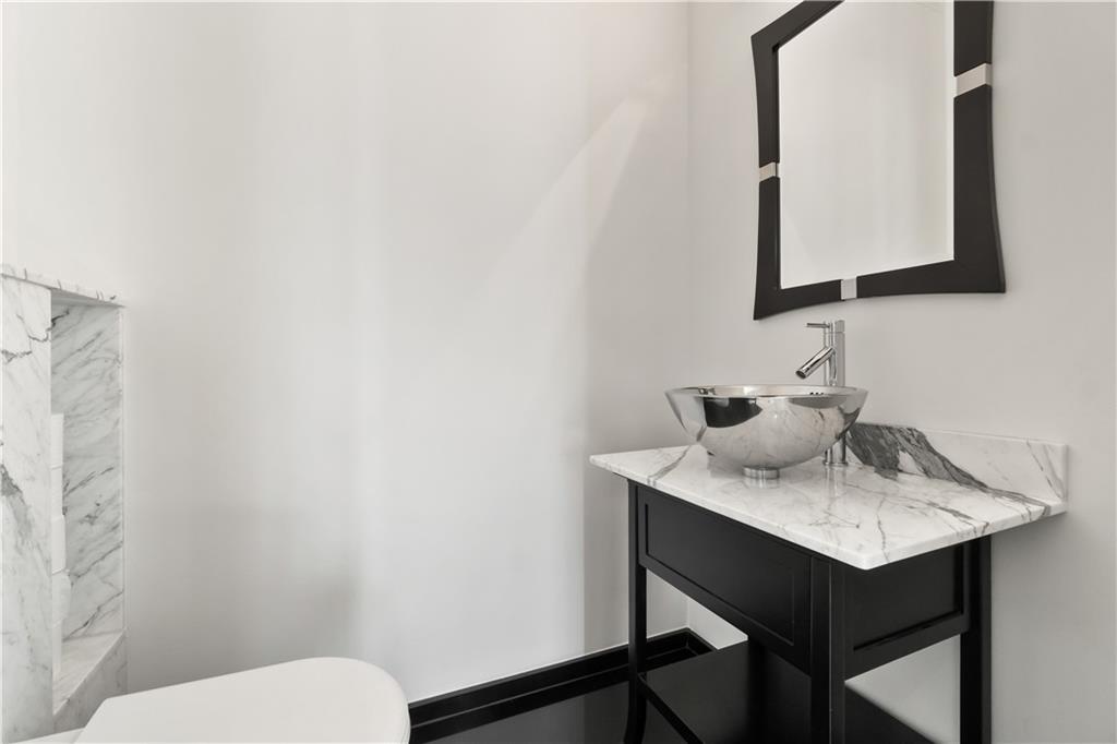 1775 Double Springs Church Road Monroe, GA 30656 - Photo 19 of 91 a bathroom with a toilet sink and mirror