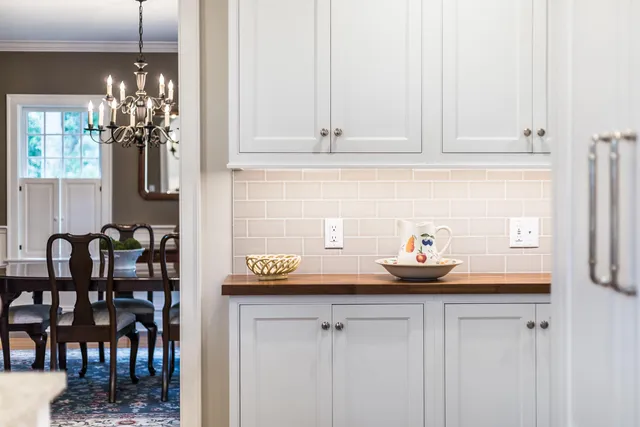 a living room with furniture a rug and a chandelier