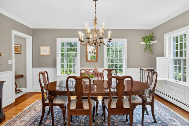 a living room with furniture and a potted plant with wooden floor