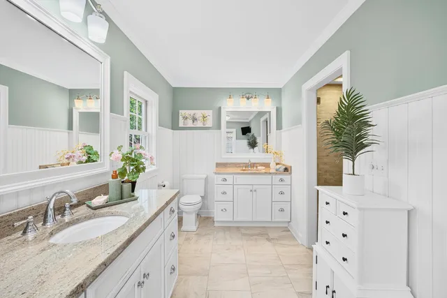 a view of a hallway to dining room and chandelier