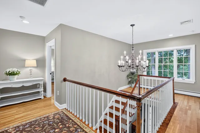 a utility room with stainless steel appliances granite countertop lots of wooden cabinets