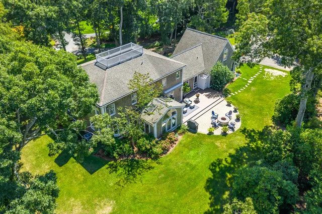 an aerial view of a house with a yard basket ball court and outdoor seating